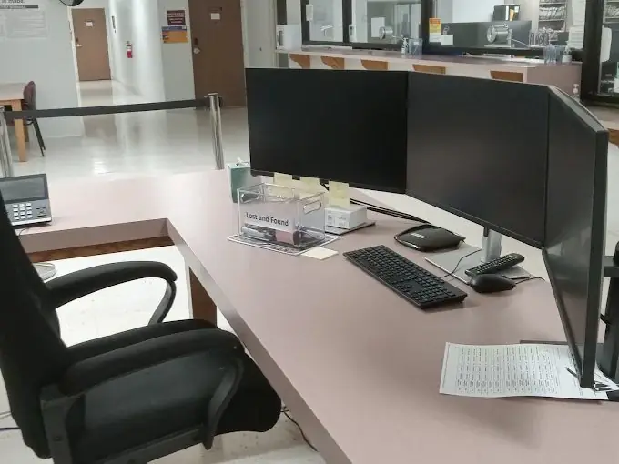 Reception desk with dual monitors in a clean commercial office, maintained by AAA All Clean Janitorial